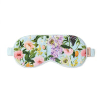 Floral print sleep mask with pink roses, purple blooms, and green leaves on light blue background