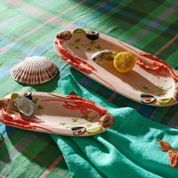 Ceramic lobster platter with shellfish decor, perfect for coastal home décor and seafood serving
