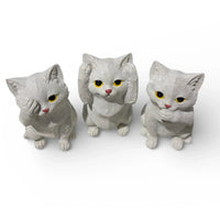 Three white cat figurines with yellow eyes, perfect for home décor or vintage-style interiors.