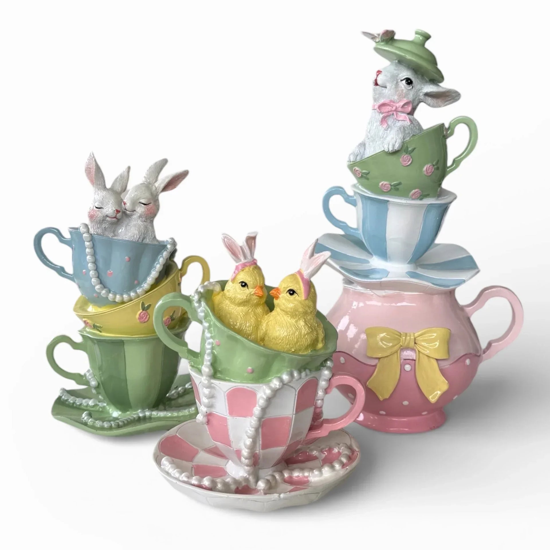 Charming Easter bunny and chick figurines nestled in pastel teacups with pearls and bows, perfect spring home décor.