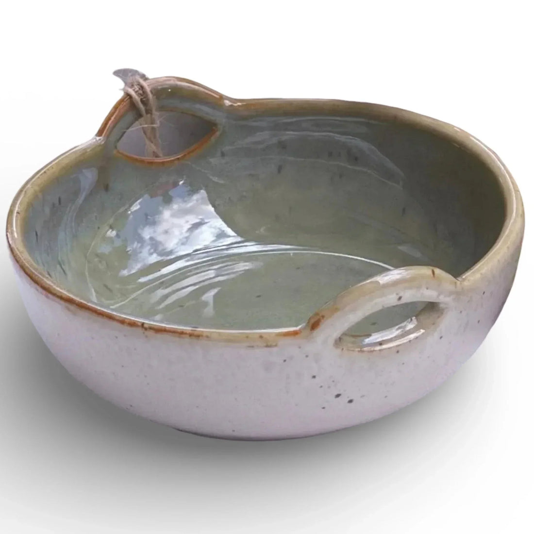 Handcrafted ceramic bowl with dual handles, speckled glaze, and rustic charm for home décor