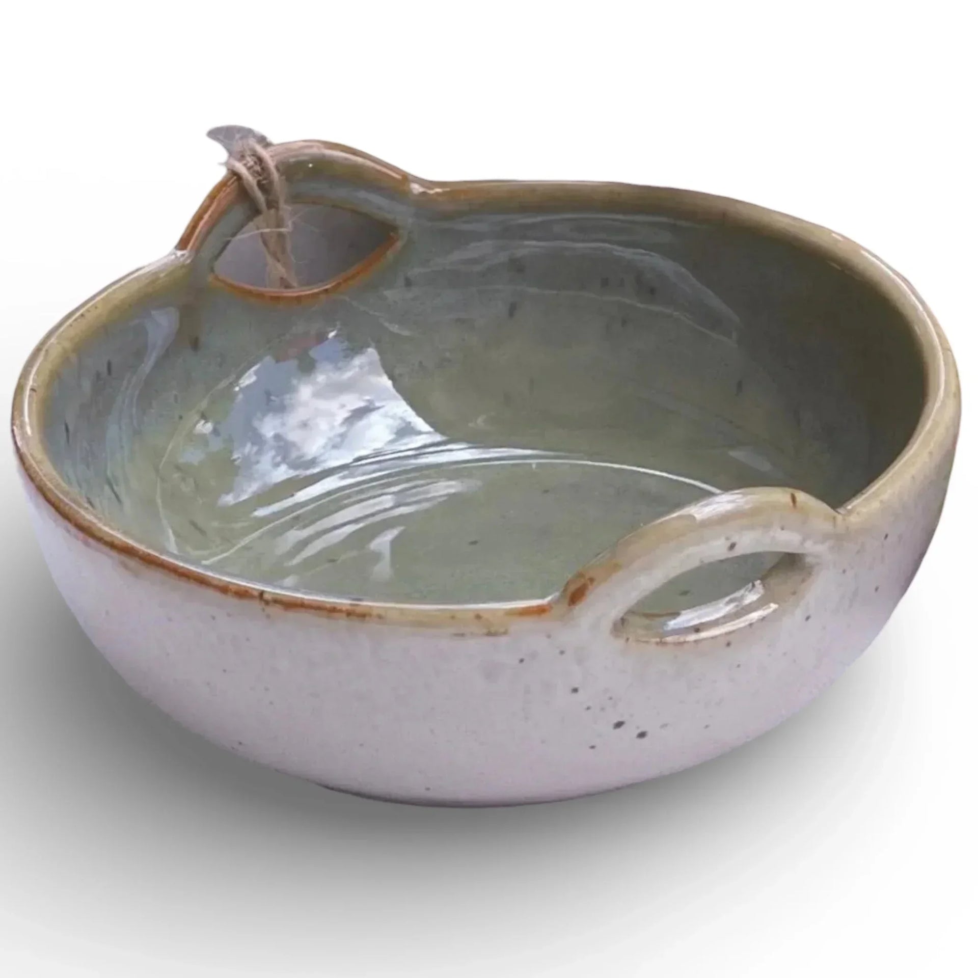 Handcrafted ceramic bowl with dual handles, speckled glaze, and rustic charm for home décor