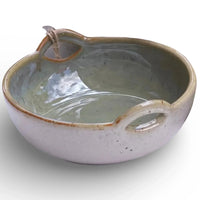 Handcrafted ceramic bowl with dual handles, speckled glaze, and rustic charm for home décor