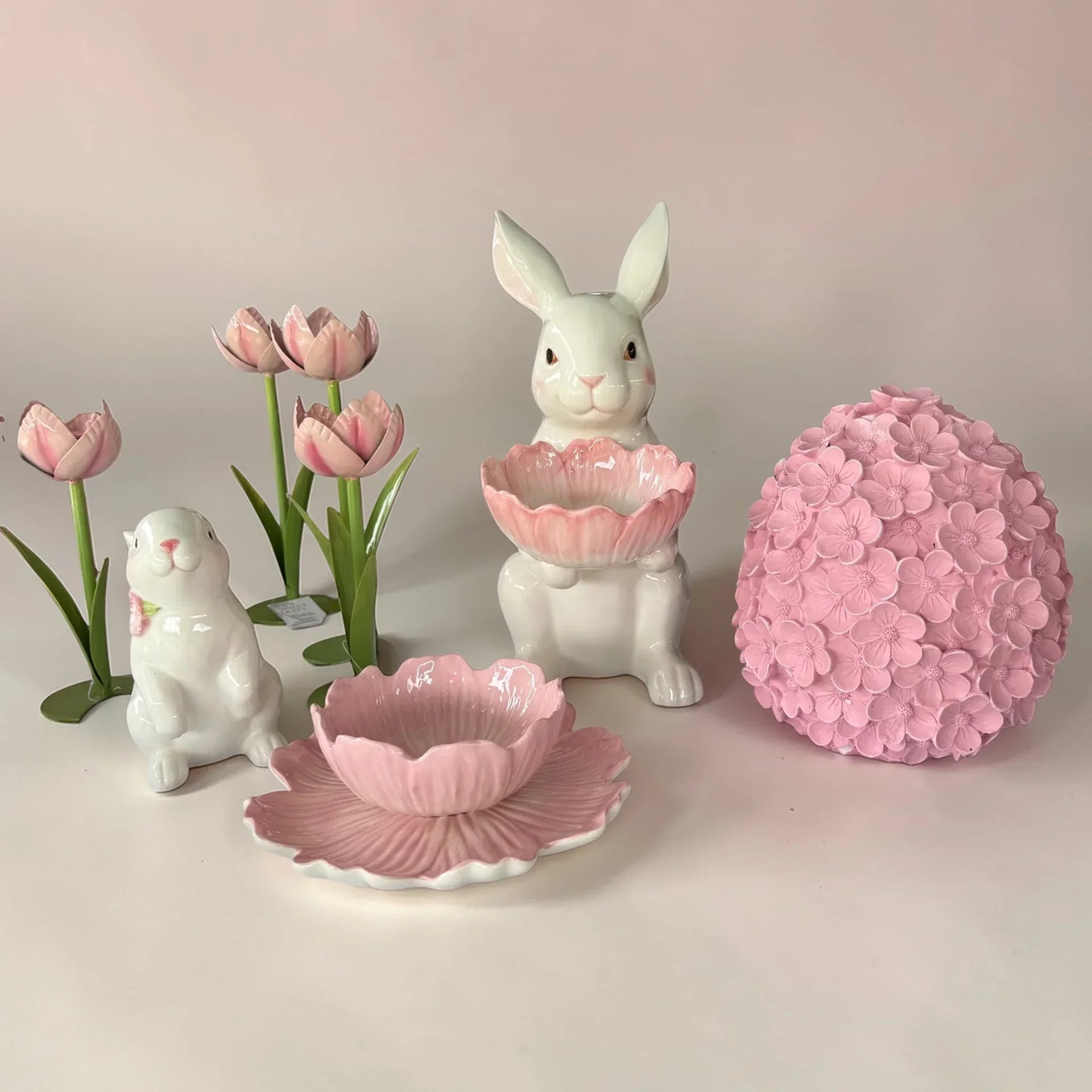 Pink and white ceramic bunny decor with tulips, flower bowl, and floral sphere for spring home styling