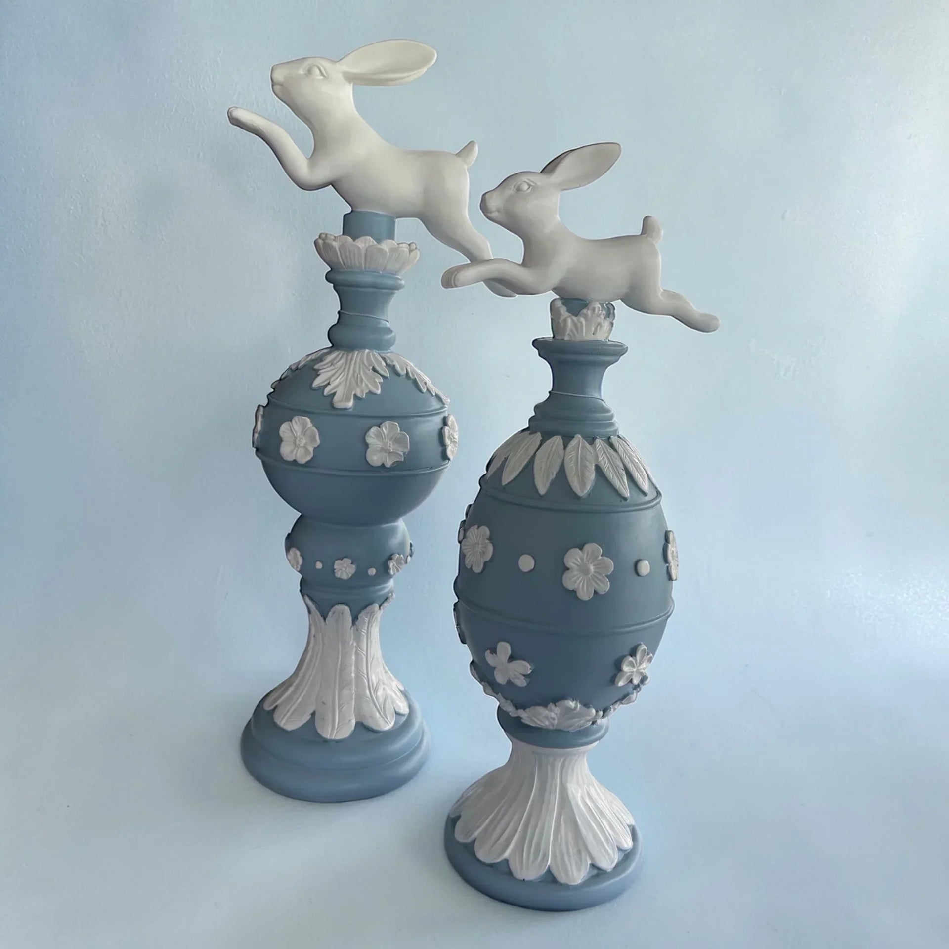 Elegant blue and white ceramic bunny figurines with floral details, perfect for vintage home décor