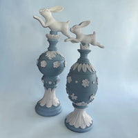 Elegant blue and white ceramic bunny figurines with floral details, perfect for vintage home décor