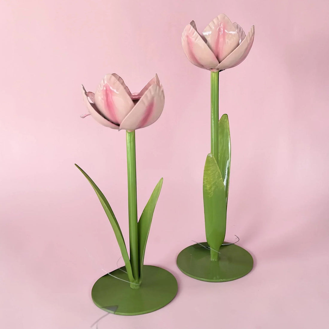 Pink metal tulip home decor with green stems and leaves, elegant spring accent for living spaces