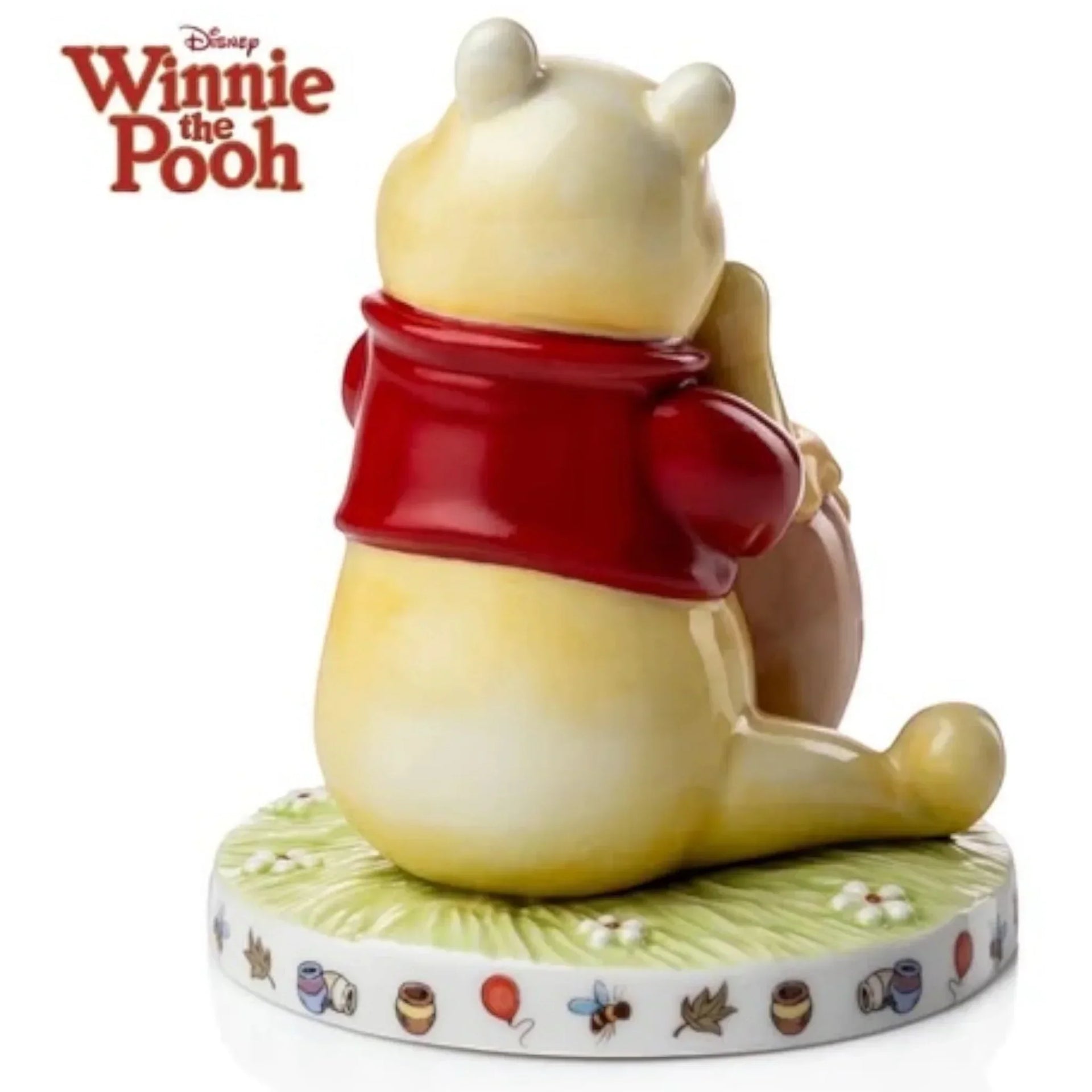 Winnie the Pooh figurine in red shirt, sitting on floral base with honey pots and balloons, Disney collectible home décor