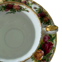 Vintage porcelain teacup with rose floral pattern and gold trim, elegant home décor accent