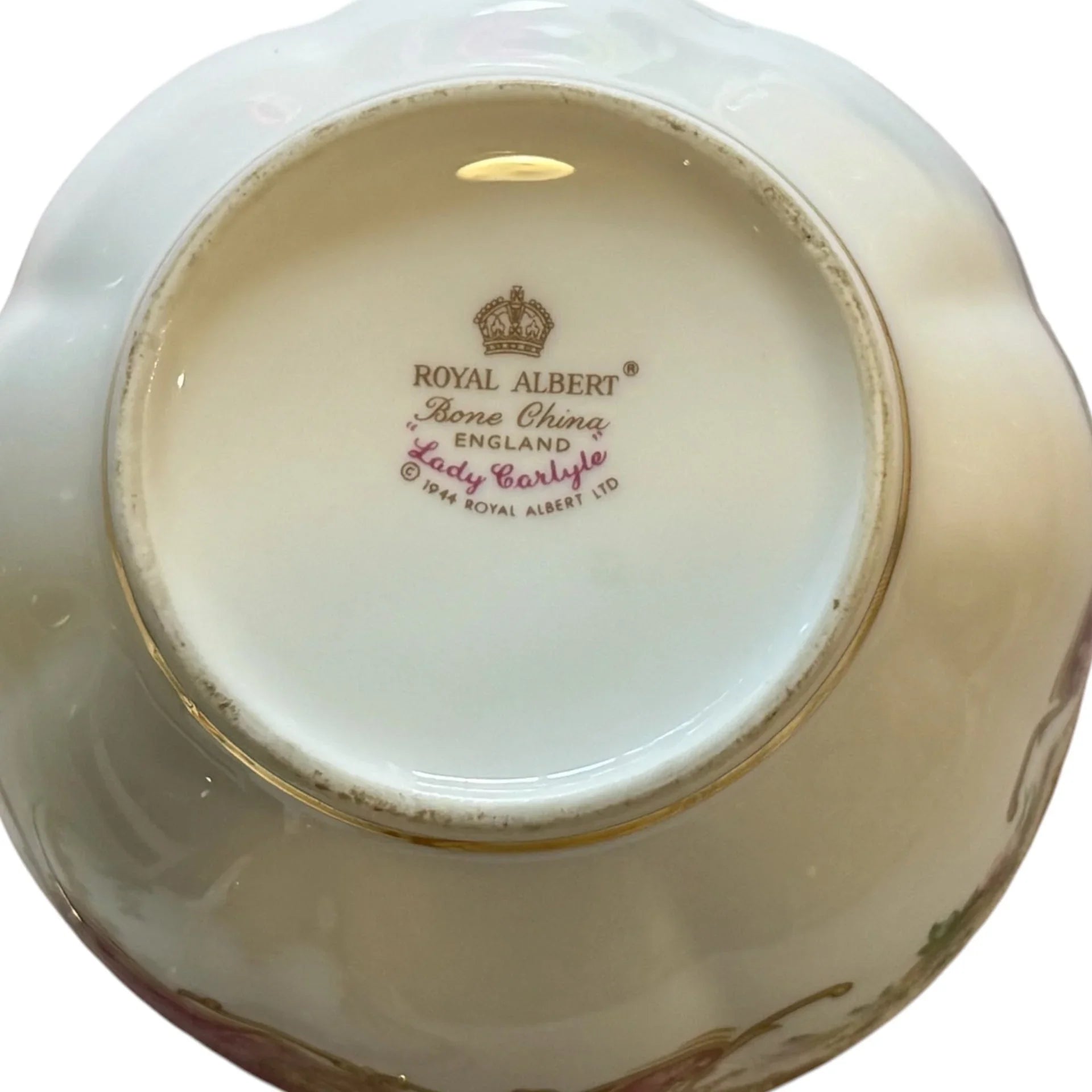 The bottom of a Royal Albert Bone Chime Lady Earleye England ceramic dish, showing the printed brand logo and name in gold and pink on the glossy white glaze.
