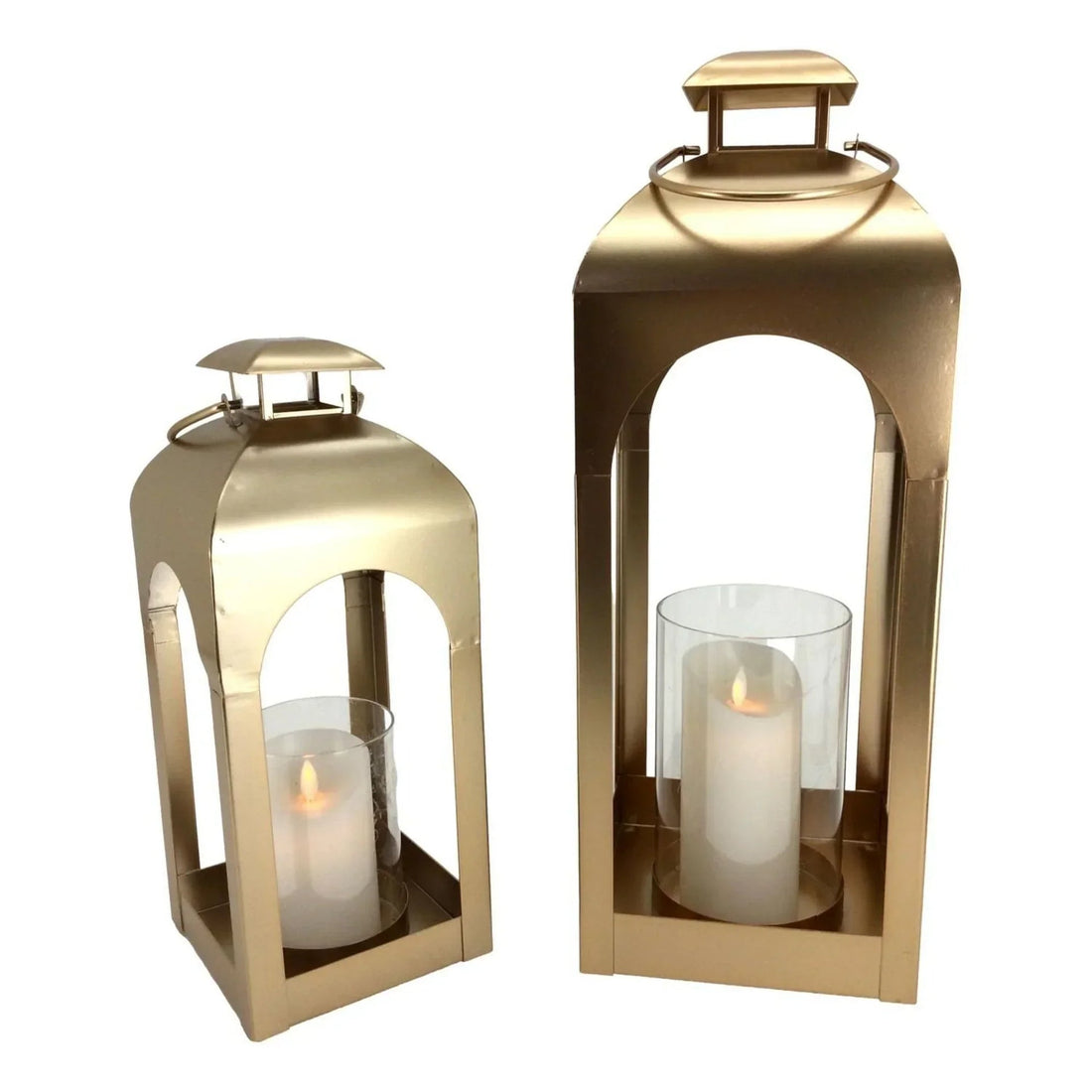 Set of two gold metal lanterns with arched openings, holding lit pillar candles for home décor