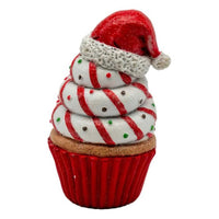 Festive cupcake with Santa hat, red and white swirls, holiday decoration