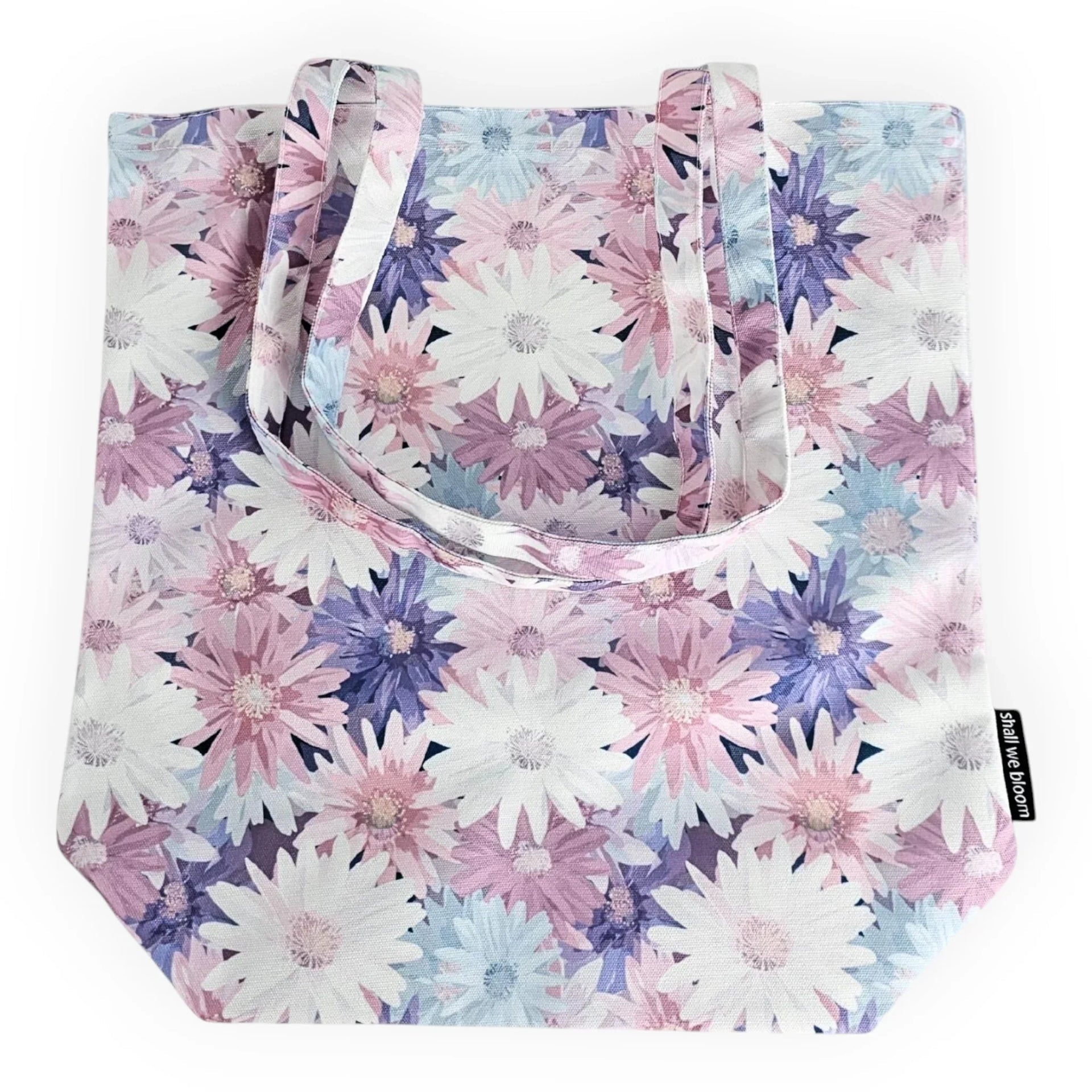 Floral tote bag with pastel daisies in pink, purple, and blue — stylish reusable shopping bag