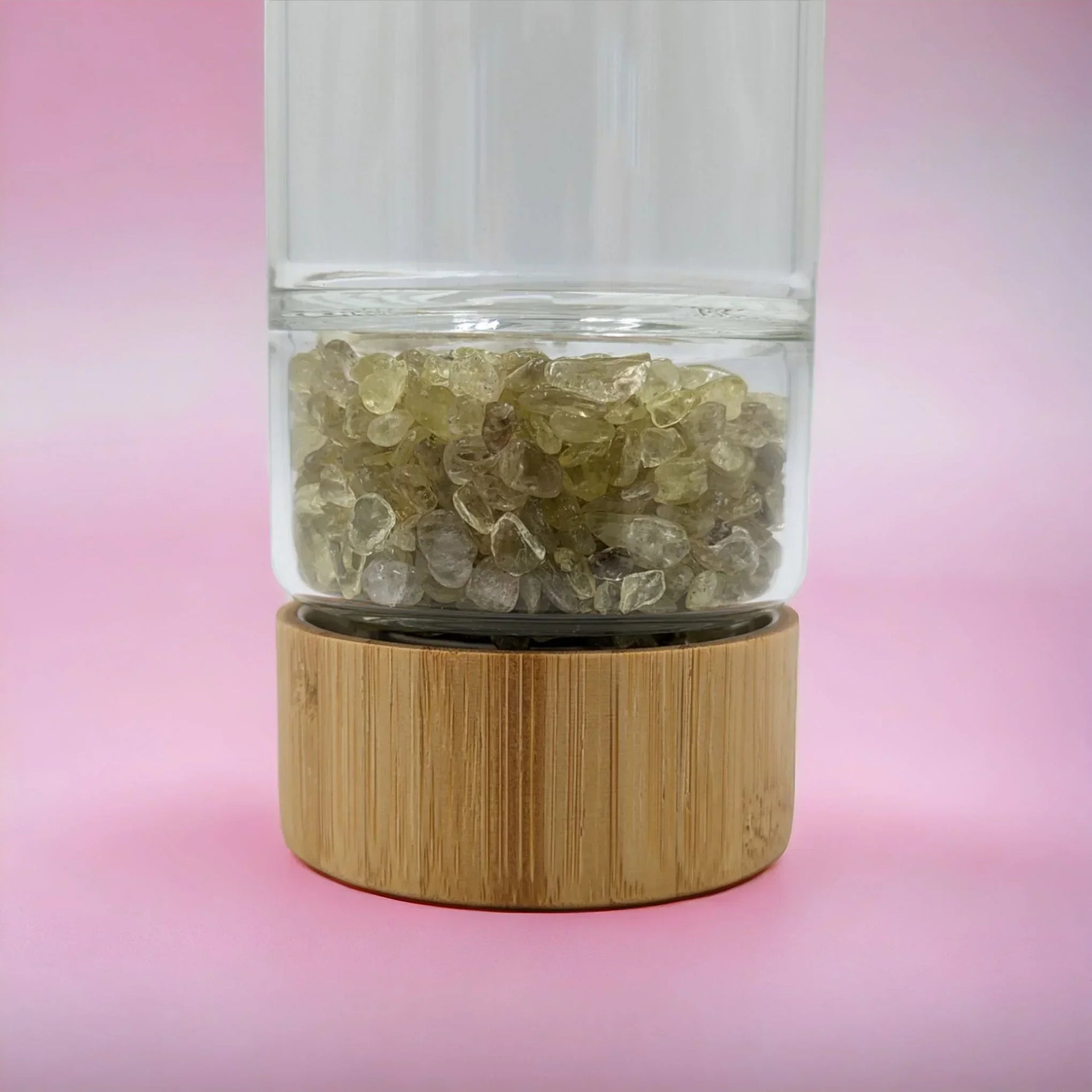 Clear glass vase with yellow crystal chips on bamboo base, home décor accent piece