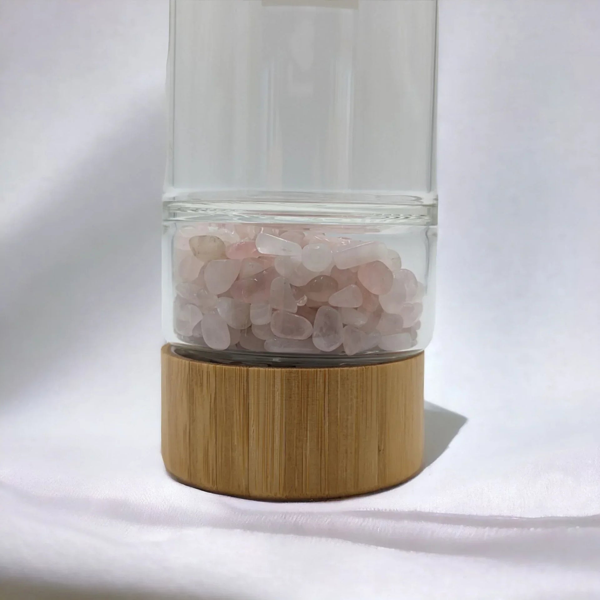 Clear glass diffuser with rose quartz stones and bamboo base, elegant home décor accent