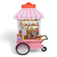Pink Santa's Workshop snow globe cart with toys, elves, and festive decorations for holiday home décor