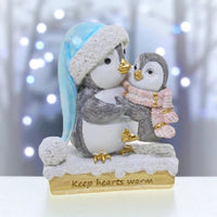 Adorable penguin figurine with baby, winter hat & scarf, 'Keep hearts warm' base — perfect home décor