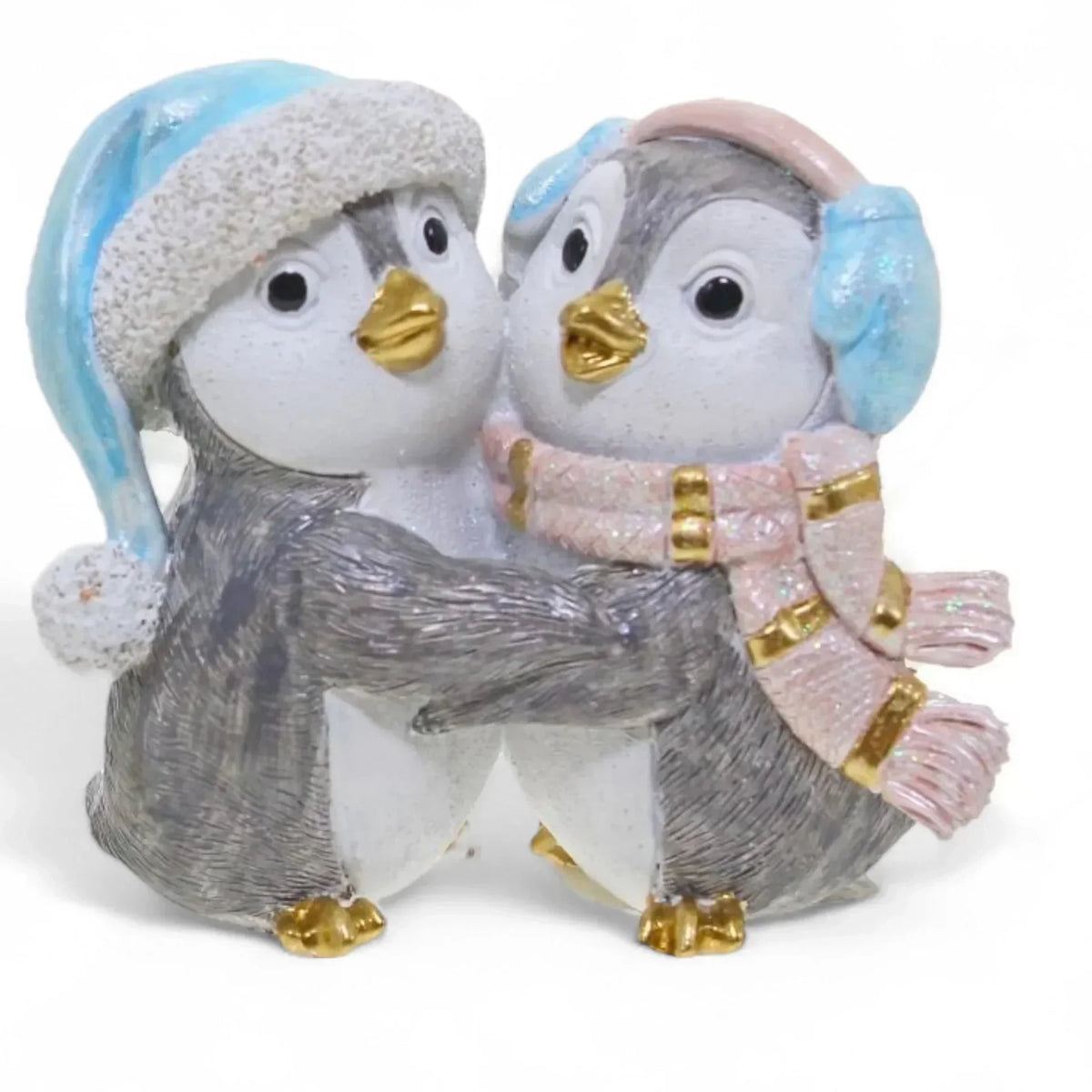 Charming penguin couple figurine in winter hats and scarves, perfect for home décor and holiday displays.