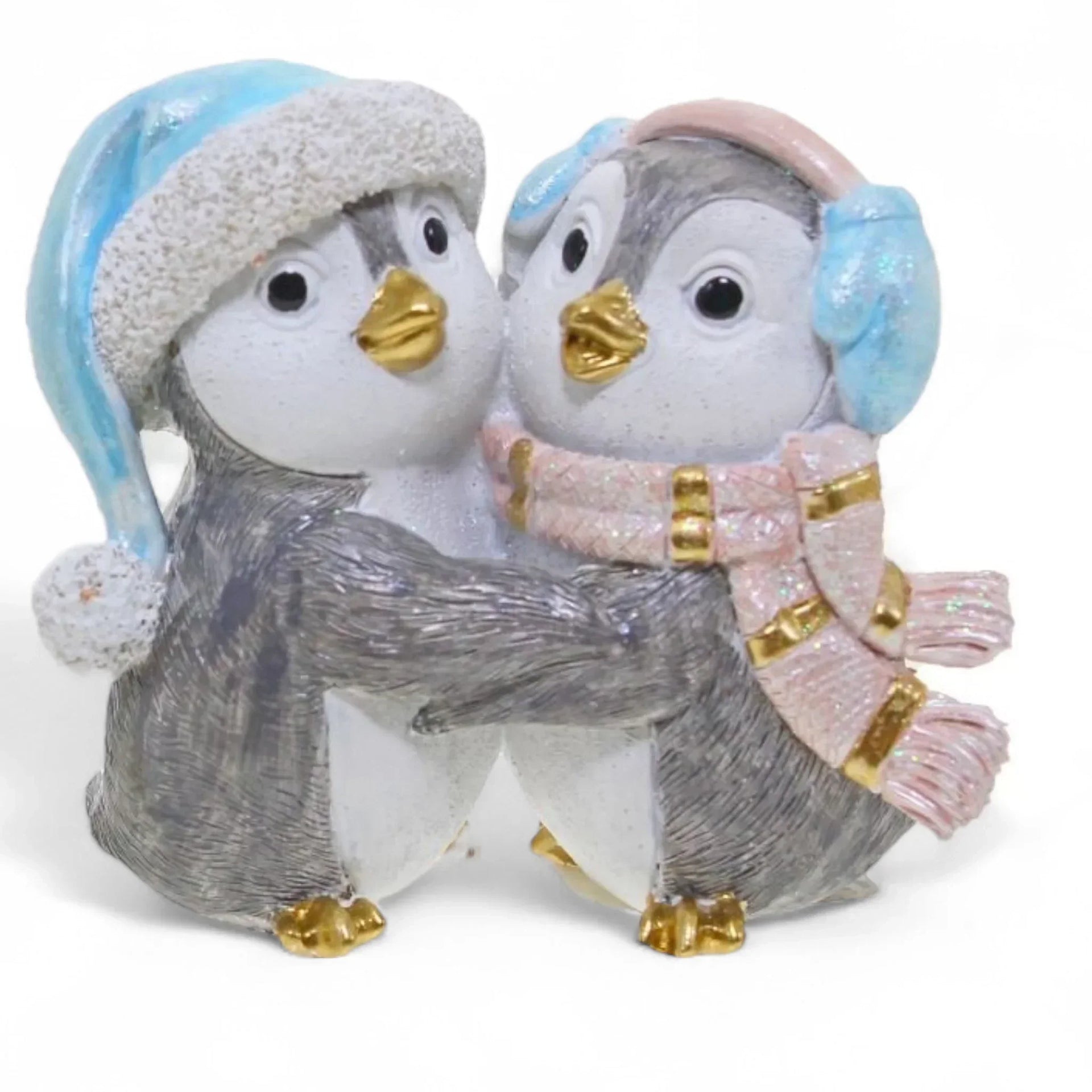 Charming penguin couple figurine in winter hats and scarves, perfect for home décor and holiday displays.