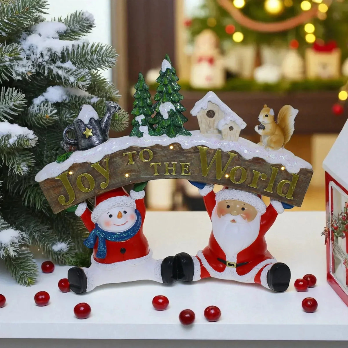 Santa and snowman holding 'Joy to the World' sign with Christmas trees, squirrel, and lights for festive home décor