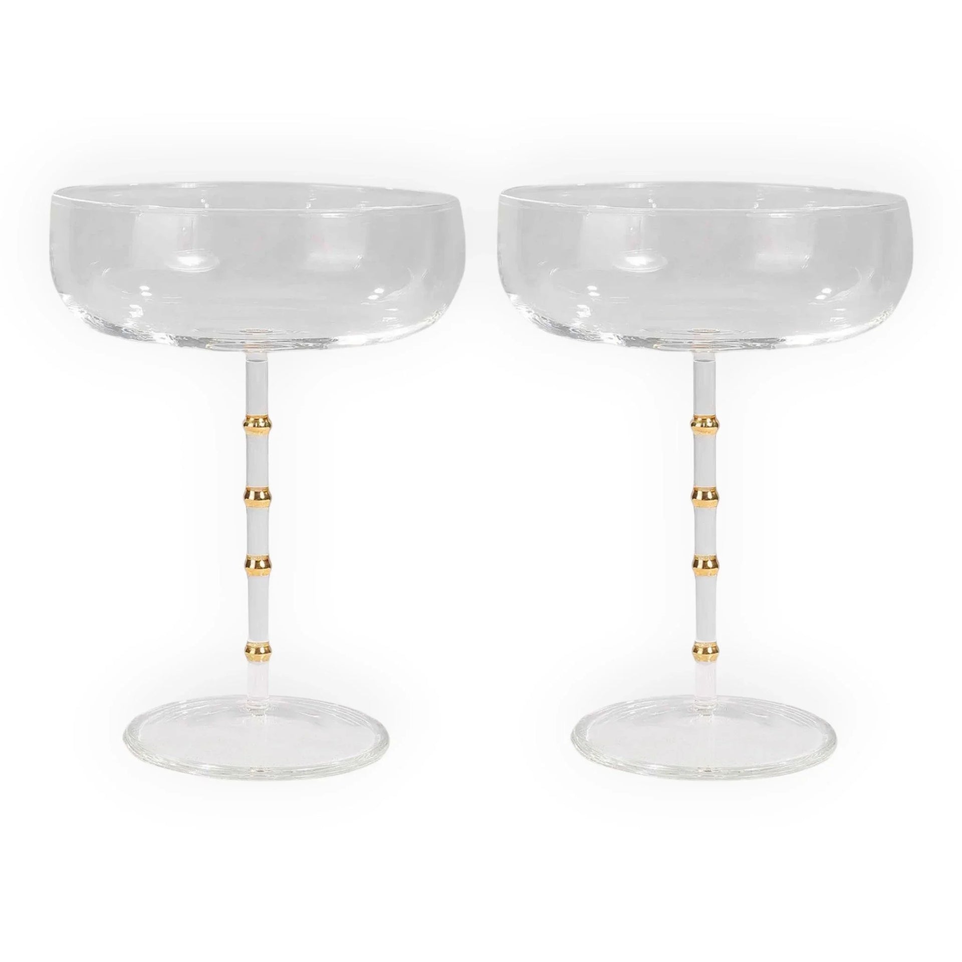Elegant champagne coupes with gold-accented stems, perfect for luxury home décor and vintage-inspired entertaining.