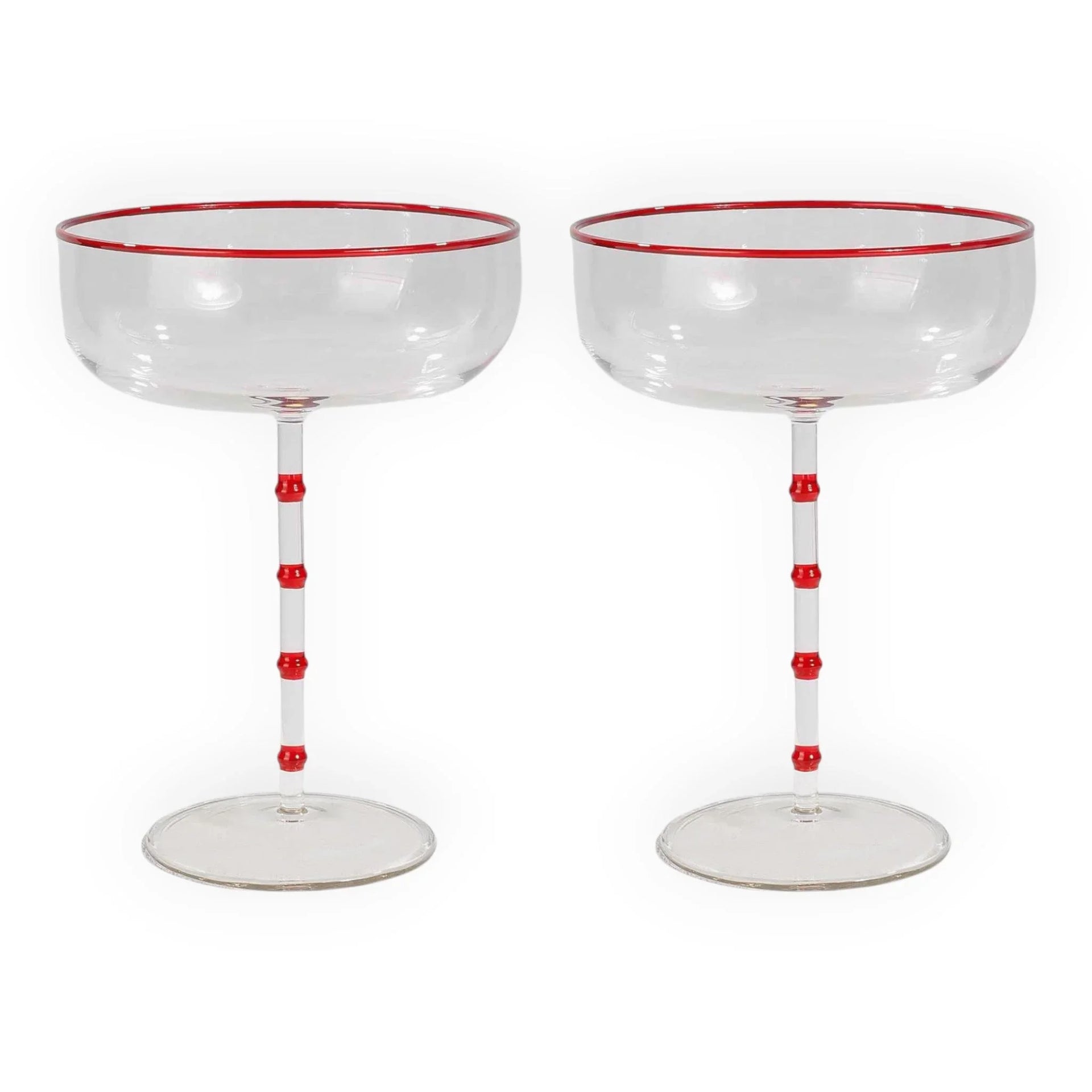 Red-rimmed coupe glasses with bamboo-style stems, elegant home barware for vintage-inspired entertaining.