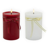 Red and white pillar candles with gold-trimmed ribbons, glowing flame for home décor ambiance
