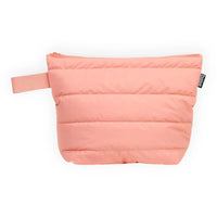 Pink quilted travel pouch with zipper and handle, ideal for cosmetics or small essentials