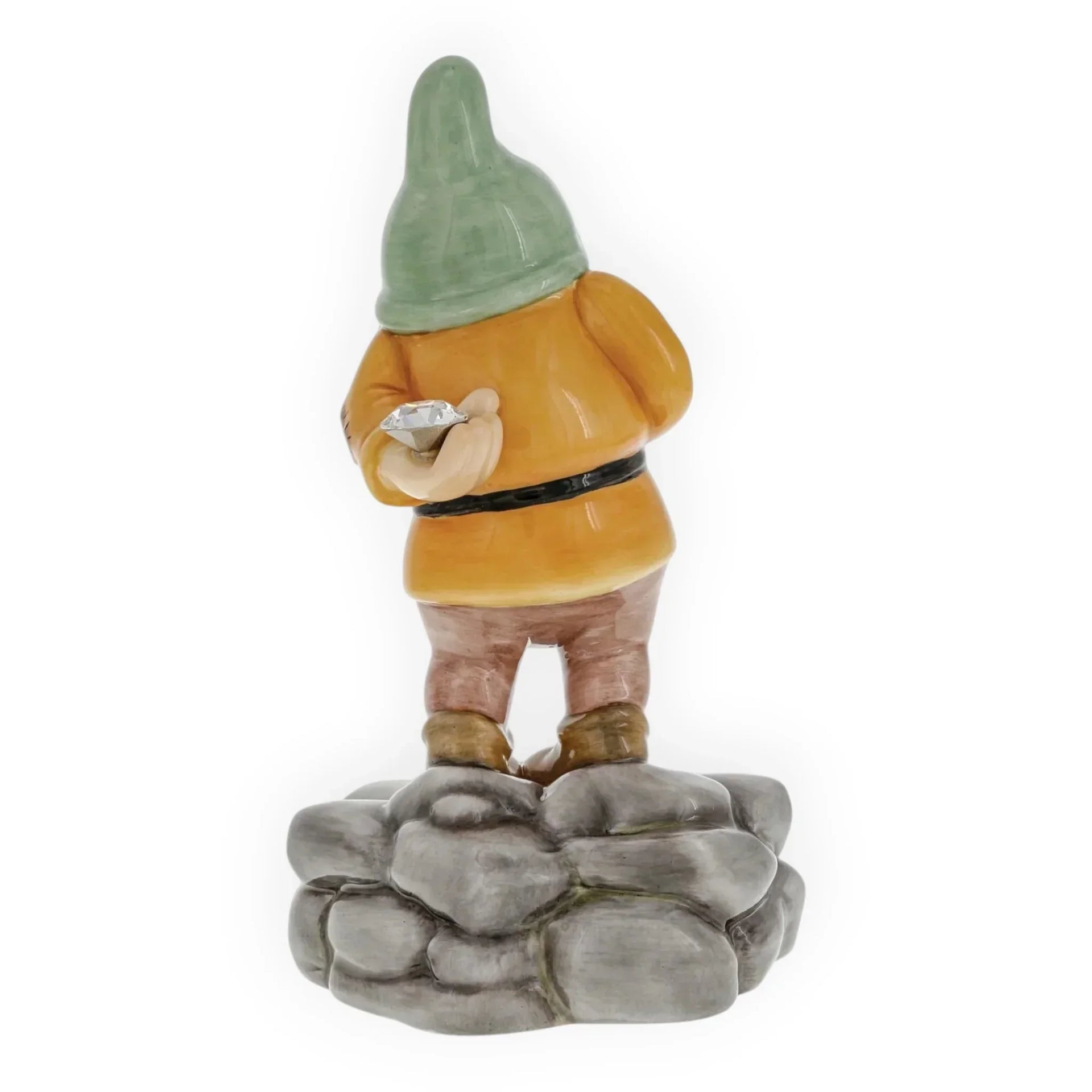 Ceramic garden gnome figurine with green hat, holding diamond, standing on rock base for home décor