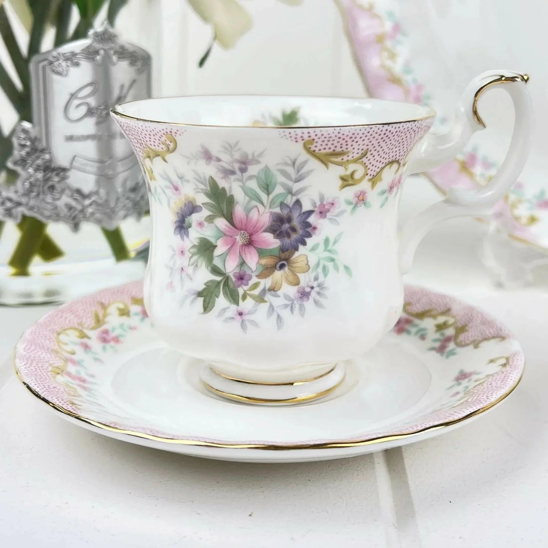 Elegant floral teacup and saucer with gold trim, perfect for home decor and tea time.