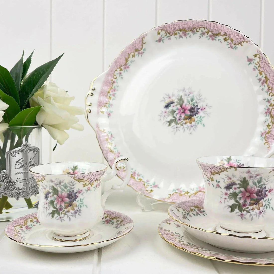 Elegant floral porcelain tea set with pink and gold accents, perfect for vintage home decor