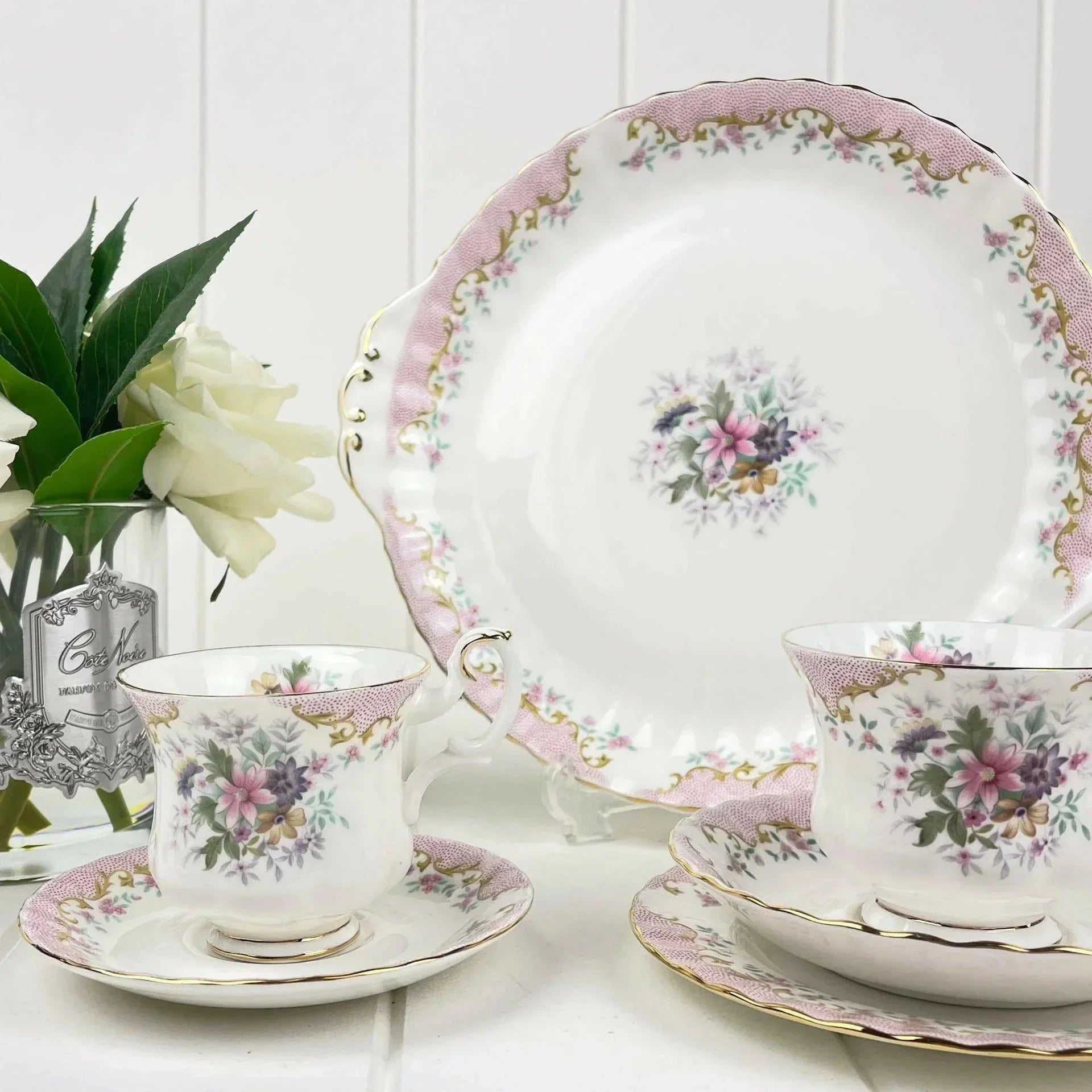 Elegant floral porcelain tea set with pink and gold accents, perfect for vintage home decor