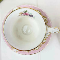 Elegant floral teacup with gold trim and pink saucer, perfect for home decor