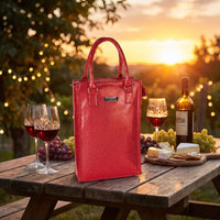 Sparkling red wine tote bag on picnic table with wine glasses, cheese, and grapes at sunset
