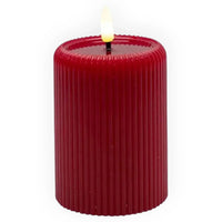 Coast to Coast red LED flameless pillar candle with ribbed texture and glowing flame