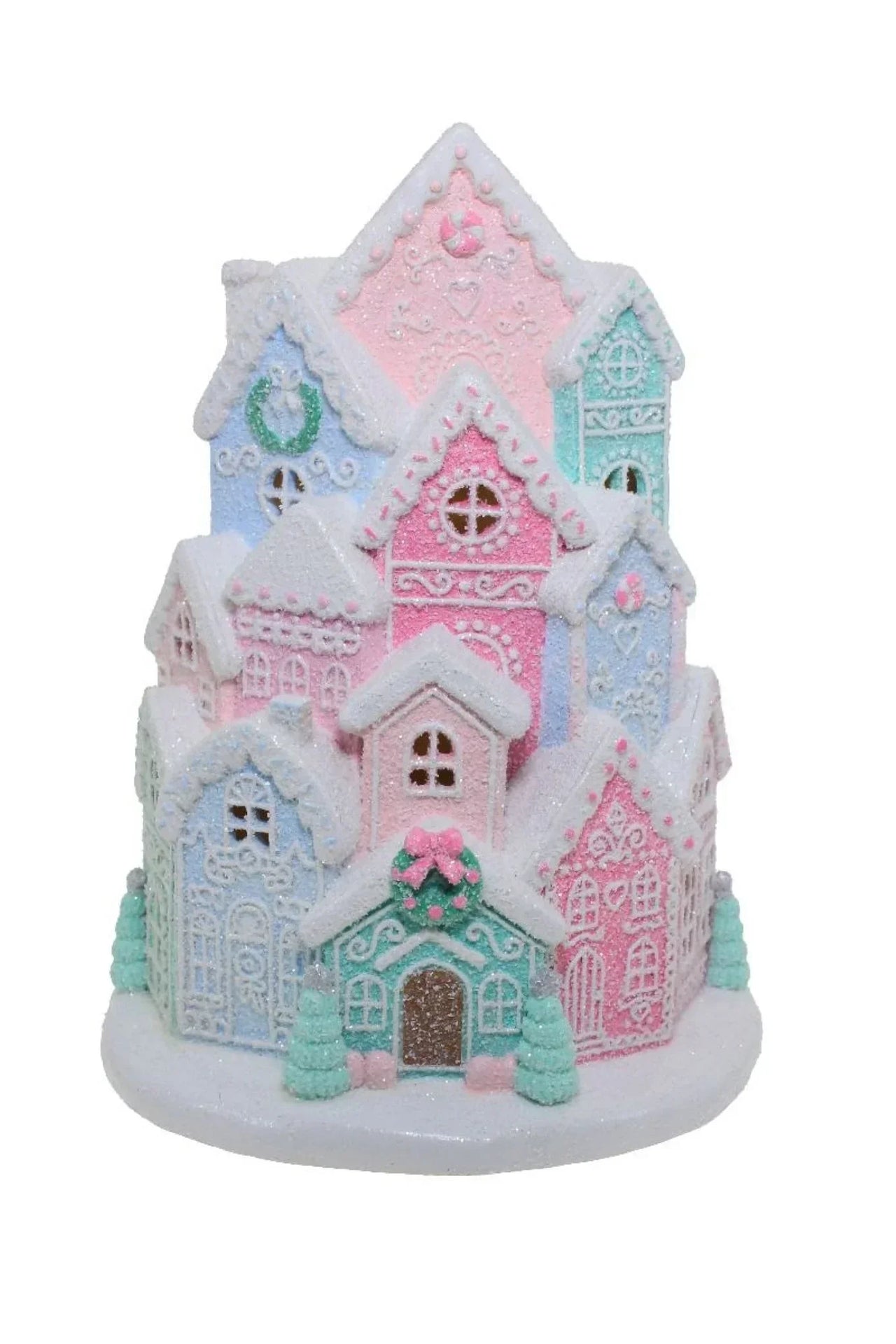 Pastel glitter gingerbread village with snow-dusted roofs, festive wreaths, and candy accents for holiday home décor
