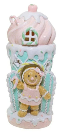 Gingerbread girl figurine in pastel cupcake house, festive home décor accent