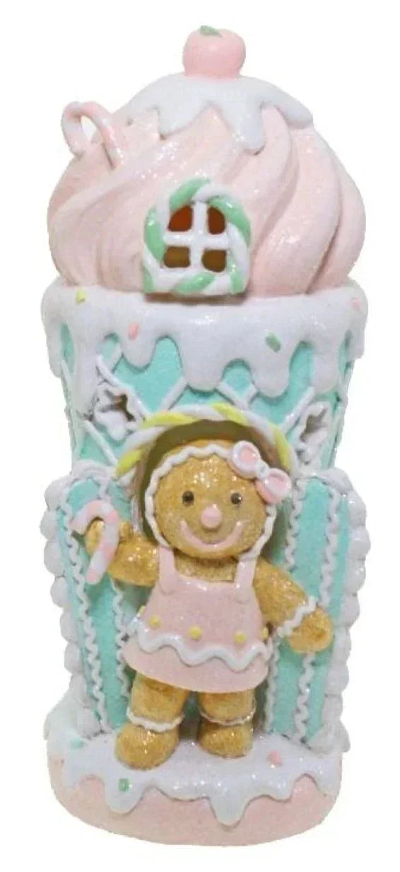 Gingerbread girl figurine in pastel cupcake house, festive home décor accent